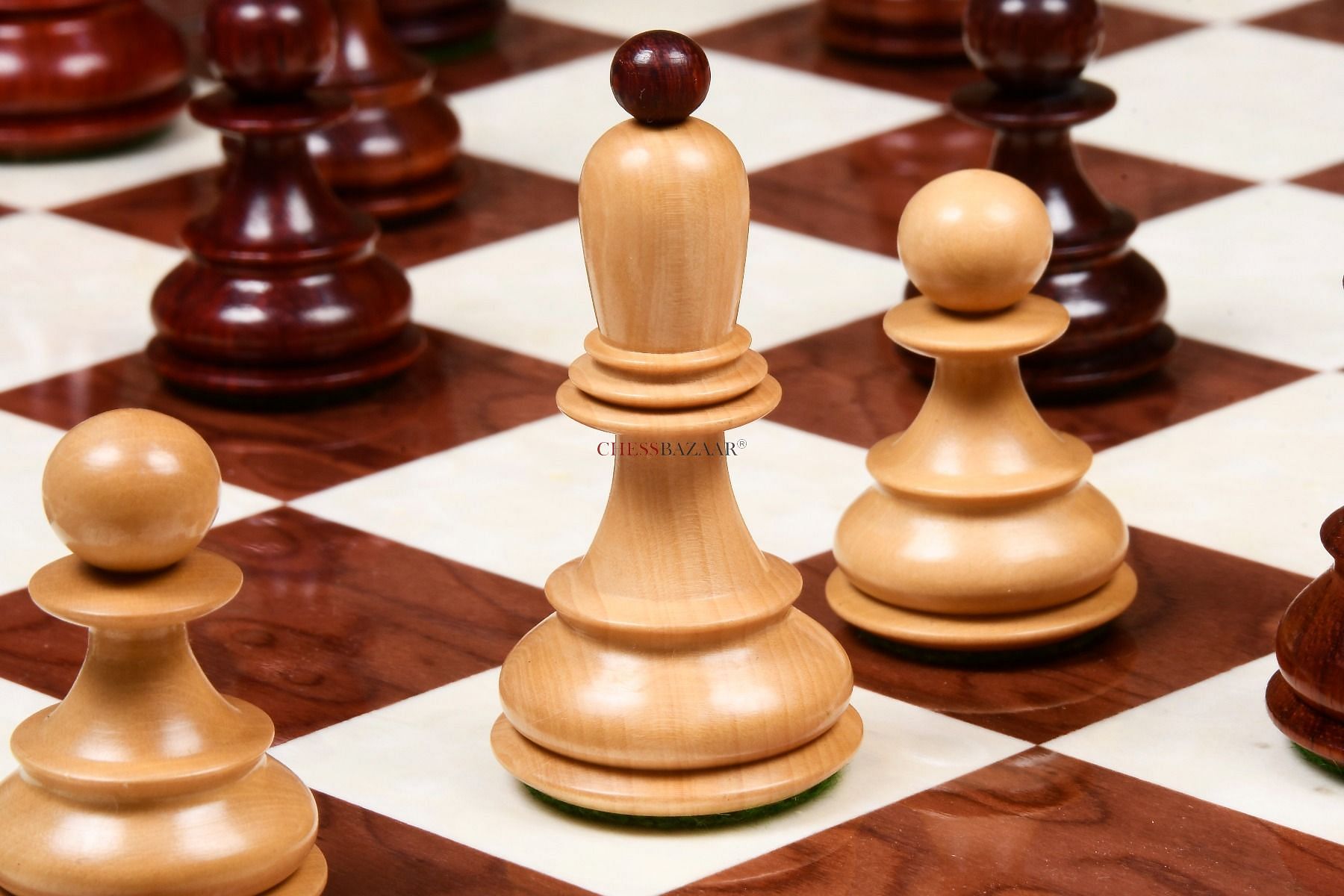Light colored Dubrovnik chess pieces on a wooden chess board